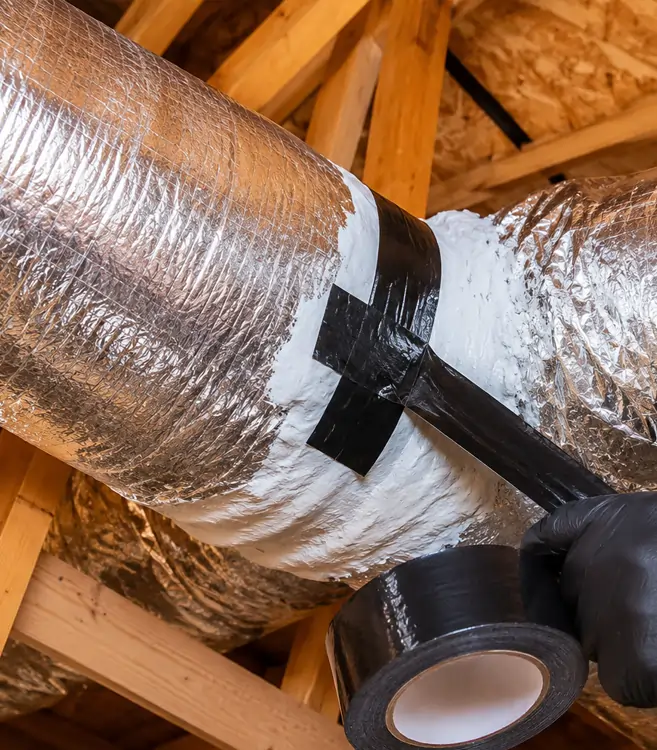 Duct Sealing with Mastic Sealant Close-up of professional HVAC duct sealing